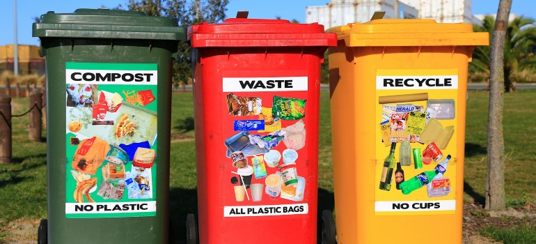 Red, yellow, and green trash bins