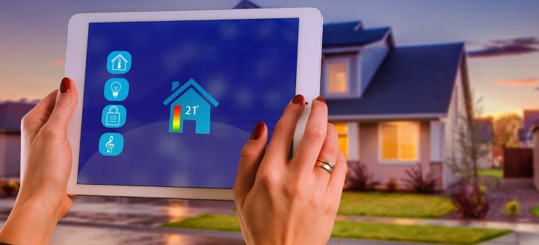 A person controlling house temperture using a tablet